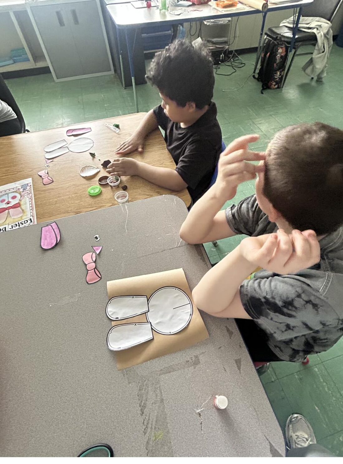 Older children working on a detailed craft project together